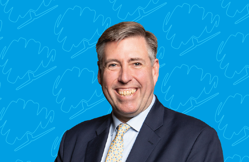 Portrait of Sir Graham Brady MP on a blue background